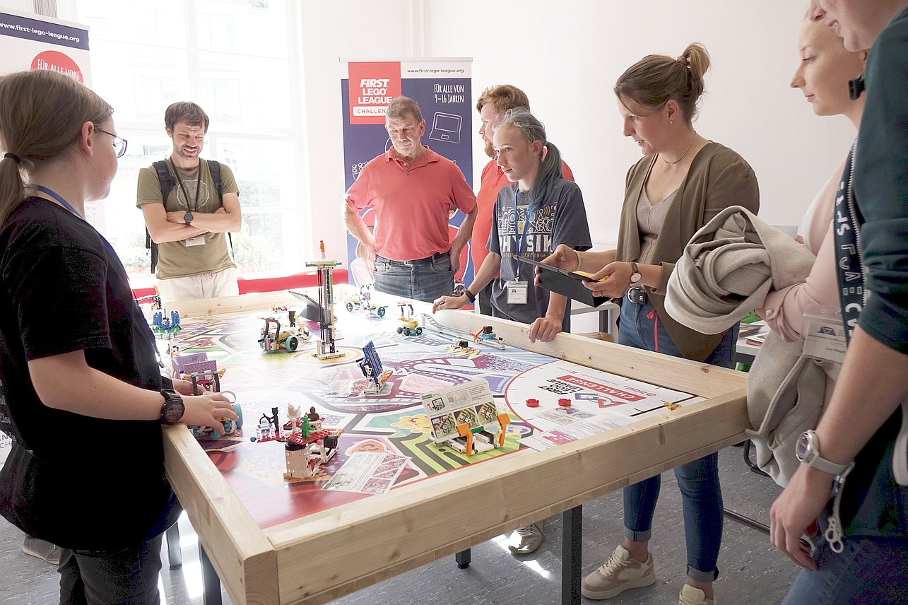 Schülerinnen und Schüler trainieren ihre Roboter an einem Spielfeld im Schüler:innen-Forschungszentrum Mittelhessen (Foto: Regionalmanagement Mittelhessen)